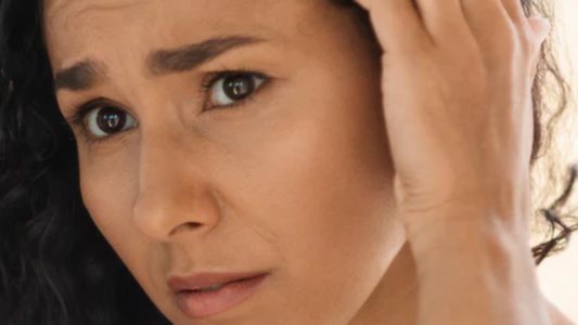woman looking at hair to check for dandruff