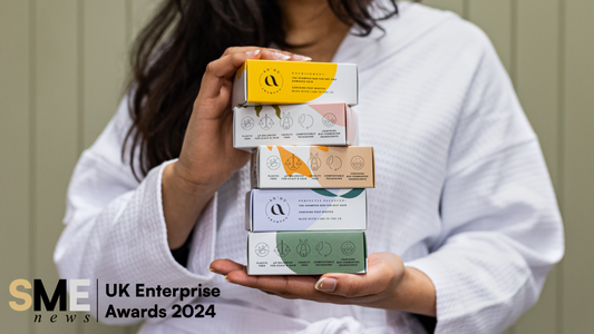 Woman holding An'du Shampoo Bars in a stack