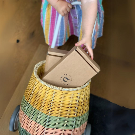 small child taking an An'du box from a basket