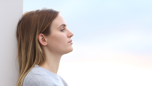 Woman with smooth but flat hair reflecting on conditioner build-up and scalp balance